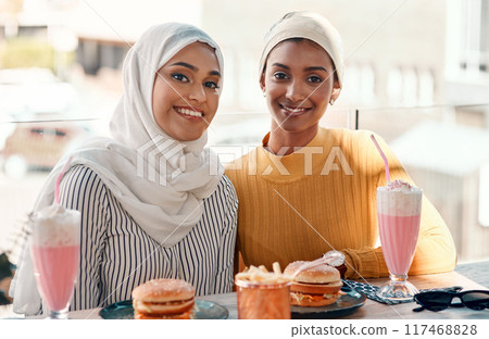 Islamic women, friends and portrait in cafe with smile for fast food, milkshake and relax for bonding. Girl, muslim people and happy with hijab, hamburger and reunion with connection in restaurant Islamic women, friends and portrait in cafe with smile for fast food, milkshake and relax for bonding. Girl, muslim people and happy with hijab, hamburger and reunion with connection in restaurant 117468828