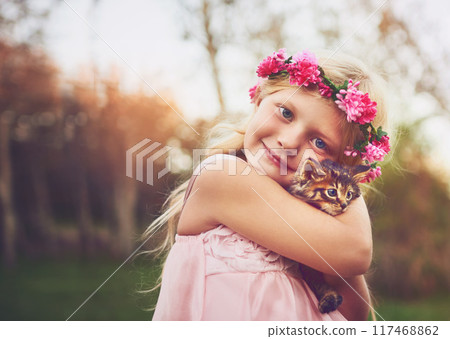 Girl, portrait and garden with kitten for love or furry companion for comfort, friendship and growth or development. Kid, flower crown and cute animal in nature with affection, bonding and playing. 117468862