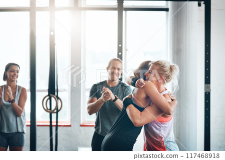 Teamwork, gym and women with hug, fitness and clapping of success, athlete or celebration in club for sports. Congratulations, happy or applause for exercise, practice and people together for workout Teamwork, gym and women with hug, fitness and clapping of success, athlete or celebration in club for sports. Congratulations, happy or applause for exercise, practice and people together for workout 117468918