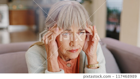 Senior woman, thinking and depressed in lounge, hand and memory of past, retirement and sad in nursing home. Grandma, lonely and couch of house, remember and elderly person in living room and grief 117468989