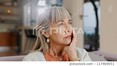 Senior woman, thinking and sad in lounge, hand and memory of past, retirement and depression in nursing home. Grandma, lonely and couch of house, remember and elderly person in living room and grief 117469051
