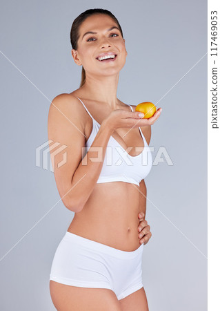 Portrait, woman and orange smiling for healthy diet, fitness and nutrition in grey studio background. Wellness, female person and fruit happy for organic meal, snack or vegan eating with vitamins 117469053