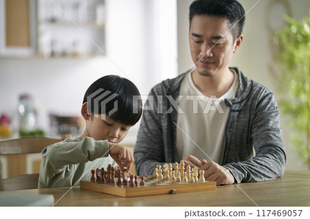 young asian father playing chess with son at home young asian father playing chess with son at home 117469057
