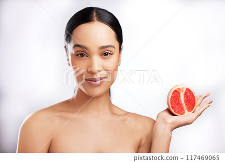 African woman, studio and portrait with grapefruit for beauty, natural cosmetics for facial. Female person, white background or makeup with smile for sustainable skincare, detox wellness or aesthetic African woman, studio and portrait with grapefruit for beauty, natural cosmetics for facial. Female person, white background or makeup with smile for sustainable skincare, detox wellness or aesthetic 117469065