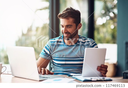 Laptop, man and tablet for planning at desk, home and office for online business. Technology, design and website development for creative person, computer or work from house for designer entrepreneur Laptop, man and tablet for planning at desk, home and office for online business. Technology, design and website development for creative person, computer or work from house for designer entrepreneur 117469113