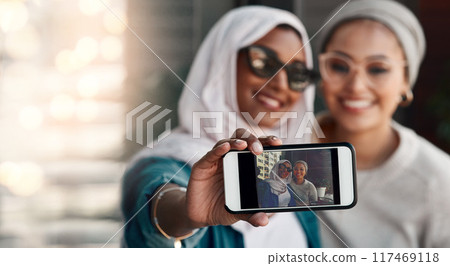 Women, friends and hijab in selfie with phone screen, smile and bonding with photography for memory. Islamic girl, people and happy with profile picture, video and app for social network in city Women, friends and hijab in selfie with phone screen, smile and bonding with photography for memory. Islamic girl, people and happy with profile picture, video and app for social network in city 117469118