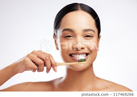 Tooth brush, portrait and woman in studio for oral health, wellness and cleaning in morning. Dental, teeth and happiness with model girl, smile and hygiene for cavities and decay by white background 117469266