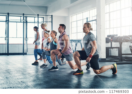People, gym and lunges for wellness workout together, group and health club training for leg strength. Strong body, balance and exercise determination with posture, collaboration and challenge People, gym and lunges for wellness workout together, group and health club training for leg strength. Strong body, balance and exercise determination with posture, collaboration and challenge 117469303