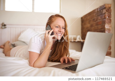 Smartphone, laptop and woman by phone call for remote work, happy at home and freelance. Communication, networking and smile with cellphone for planning, online conversation or discussion in bedroom Smartphone, laptop and woman by phone call for remote work, happy at home and freelance. Communication, networking and smile with cellphone for planning, online conversation or discussion in bedroom 117469321