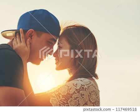 Sunset, couple and hug on beach with forehead touch for care and love in nature with sunshine. Happiness, man and woman outdoor for travel, adventure and holiday to Thailand for vacation in summer Sunset, couple and hug on beach with forehead touch for care and love in nature with sunshine. Happiness, man and woman outdoor for travel, adventure and holiday to Thailand for vacation in summer 117469518