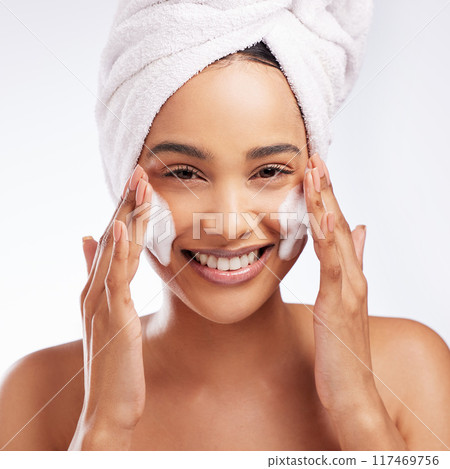 Foam, hands and portrait of woman in studio with skincare for cosmetic, natural glow or treatment on white background. Towel, body and model cleaning face for wellness, dermatology or morning routine Foam, hands and portrait of woman in studio with skincare for cosmetic, natural glow or treatment on white background. Towel, body and model cleaning face for wellness, dermatology or morning routine 117469756