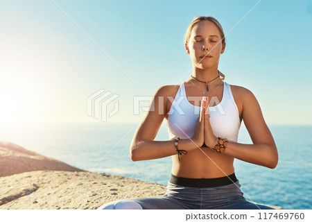 Outdoor, prayer hands and woman with zen for yoga, wellness and spiritual peace in California. Chakra, female yogi and namaste with lotus pose for meditation, relax and mental health by blue sky 117469760