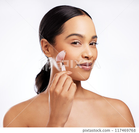 Portrait, woman and rose quartz in skincare for beauty, anti aging or dermatology on white background. Female person, cosmetic tool and face roller for results in studio backdrop for wellness or glow 117469768