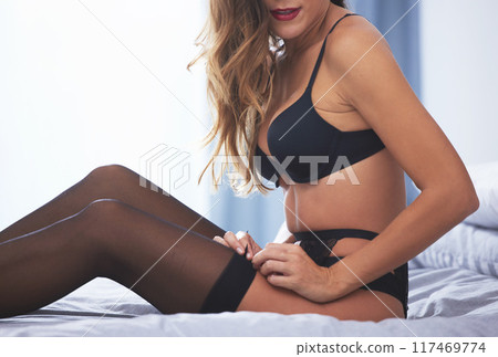 Woman, relaxing and sexy in bedroom with lingerie and curtains for seduction and comfort in apartment. Female person, underwear and sensual in home with confidence for figure, skin and summer Woman, relaxing and sexy in bedroom with lingerie and curtains for seduction and comfort in apartment. Female person, underwear and sensual in home with confidence for figure, skin and summer 117469774