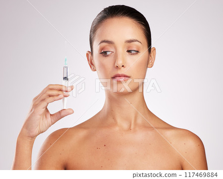 Skincare, woman and thinking in studio with syringe for facelift, cosmetology or treatment on white background. Dermal filler, needle and hand of model for anti aging, plastic surgery or injection Skincare, woman and thinking in studio with syringe for facelift, cosmetology or treatment on white background. Dermal filler, needle and hand of model for anti aging, plastic surgery or injection 117469884