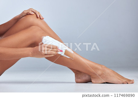 Woman, legs and cream in studio for shaving, skincare and hair removal on blue background. Person, razor and epilation on mockup space or beauty, cosmetics and lotion for treatment or dermatology Woman, legs and cream in studio for shaving, skincare and hair removal on blue background. Person, razor and epilation on mockup space or beauty, cosmetics and lotion for treatment or dermatology 117469890