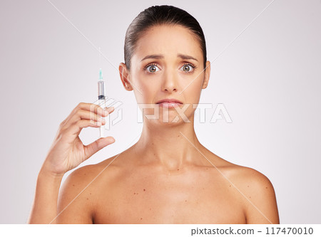 Skincare, woman portrait and scared with syringe in studio for facelift, cosmetology or treatment on white background. Filler, body and hand of model for anti aging with anxiety for injection Skincare, woman portrait and scared with syringe in studio for facelift, cosmetology or treatment on white background. Filler, body and hand of model for anti aging with anxiety for injection 117470010