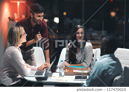 Business people, laptop and discussion for project at night in office, creative agency and overtime food for design. Teamwork, support and problem solving in pizza meeting for deadline and planning 117470020