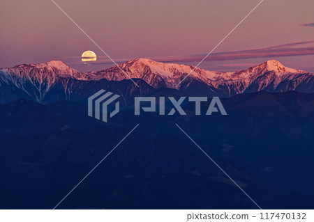 A full moon setting in the west and the Shiramine Sanzan mountains at dawn, seen from Mount Ryugatake A full moon setting in the west and the Shiramine Sanzan mountains at dawn, seen from Mount Ryugatake 117470132