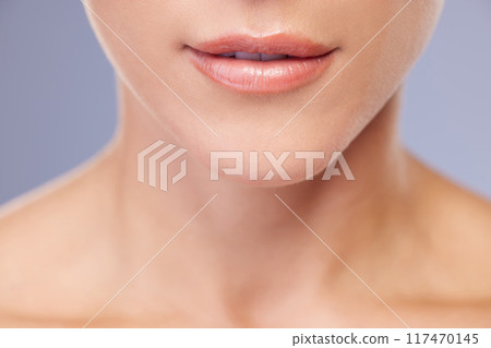 Woman, lips and skincare in studio for beauty, facial treatment and cosmetics on blue background. Female person, mouth and pamper for dermatology, grooming and confident for soft skin or wellness 117470145