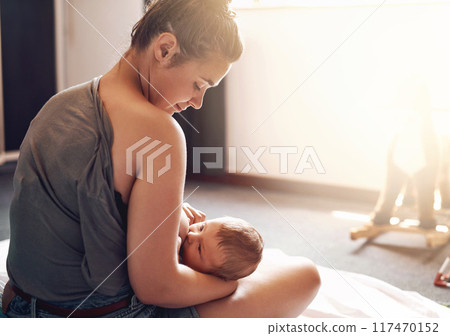 Mother, baby and breastfeeding in bedroom for growth development, nutrition or digestive health. Lens flare, back and woman with newborn child for natural milk, wellness or bonding care in home Mother, baby and breastfeeding in bedroom for growth development, nutrition or digestive health. Lens flare, back and woman with newborn child for natural milk, wellness or bonding care in home 117470152