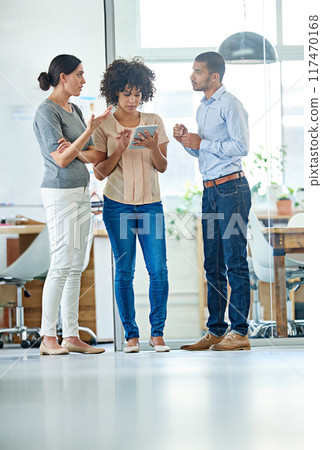 Planning, team and people in office with tablet for collaboration or business networking in startup. Workplace, employees and digital project with group for ideas with technology in company. Planning, team and people in office with tablet for collaboration or business networking in startup. Workplace, employees and digital project with group for ideas with technology in company. 117470168