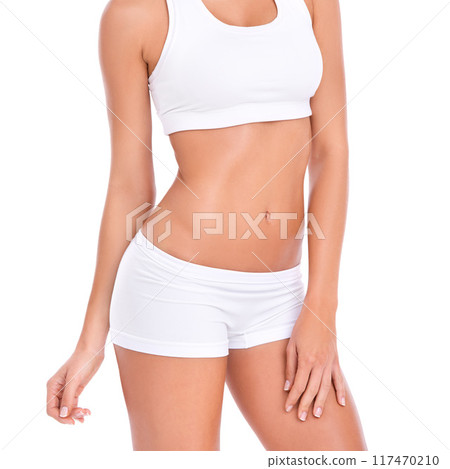 Body, stomach and woman in underwear for fitness, health and wellness with benefits in studio. Diet, exercise and girl in sportswear for self care, weight loss and results on white background. Body, stomach and woman in underwear for fitness, health and wellness with benefits in studio. Diet, exercise and girl in sportswear for self care, weight loss and results on white background. 117470210