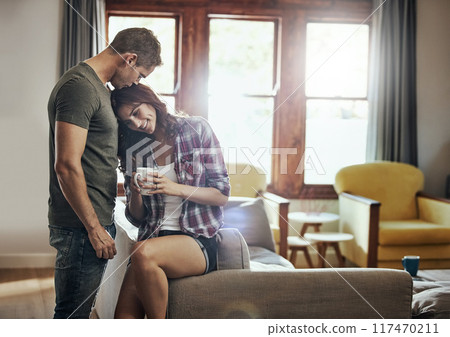 Couple, coffee and home with love, kiss and smile in marriage, relax and peace in break and morning. House, man and woman on sofa, together and rest in living room, bonding and happy for relationship Couple, coffee and home with love, kiss and smile in marriage, relax and peace in break and morning. House, man and woman on sofa, together and rest in living room, bonding and happy for relationship 117470211