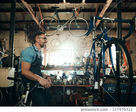Bicycle technician, planning and working in shop with frame, chain and tools for maintenance or cycling. Mechanic, bike and man in workshop as handyman for gear, inspection and safety with glasses Bicycle technician, planning and working in shop with frame, chain and tools for maintenance or cycling. Mechanic, bike and man in workshop as handyman for gear, inspection and safety with glasses 117470322