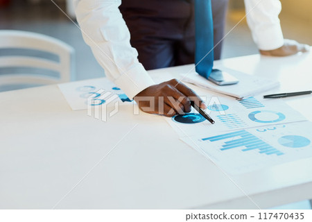 Businessman, hands and documents with statistics for finance, budget or corporate growth on office desk. Closeup of male person or employee with paperwork, graph or charts on table at workplace 117470435