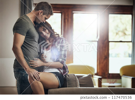Couple, coffee and smile with hug, living room and happy in marriage, relax and peace in break and morning. House, man and woman on sofa, together and rest in lounge bonding and embrace in weekend 117470536