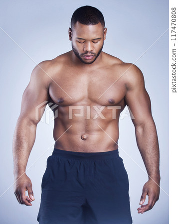 Fitness, body and strong man in studio for training, wellness or abs progress, mindset or power on grey background. Sports, face and calm African athlete with sixpack, growth and abdomen muscle flex 117470808