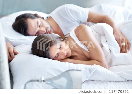 Couple, sleeping and rest in bedroom for peace, love and hug in bed. Man, woman and dreaming together at home for relaxation, comfort and trust in relationship or sleep in on weekend in apartment Couple, sleeping and rest in bedroom for peace, love and hug in bed. Man, woman and dreaming together at home for relaxation, comfort and trust in relationship or sleep in on weekend in apartment 117470851