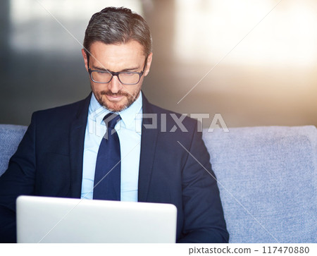 Laptop, lobby and business man on sofa in office for email, information or research for administration. Break, computer and corporate with professional employee typing online report in workplace 117470880