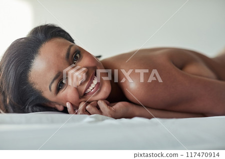 Woman, happy and portrait for seduction, naked and natural makeup glow for beauty or smile in bedroom. Model, nude and happiness for sexy body, sensual and attractive in home with beautiful person 117470914