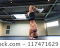 Young man with an athletic body practicing breakdance indoors 117471629