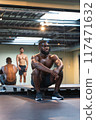 Black athlete resting during training with his teammate 117471632