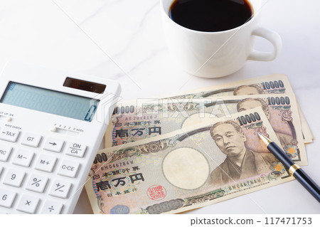 A 10,000 yen bill with a portrait of Yukichi Fukuzawa, a calculator, a pen, and a coffee cup with freshly brewed coffee. 117471753
