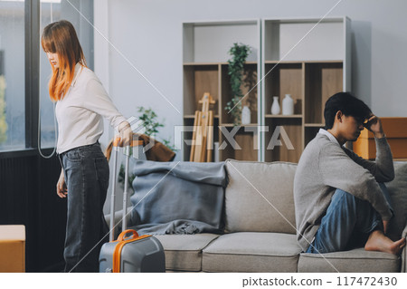 Offended couple ignoring each other after quarrel indoors, selective focus. Relationship problems Offended couple ignoring each other after quarrel indoors, selective focus. Relationship problems 117472430