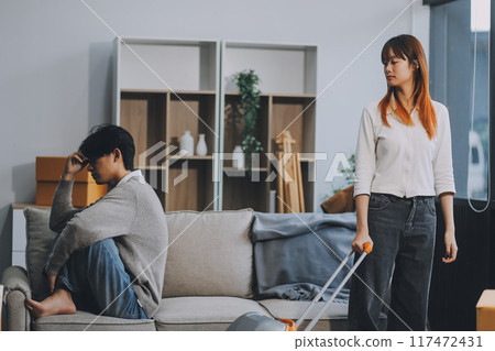 Offended couple ignoring each other after quarrel indoors, selective focus. Relationship problems 117472431