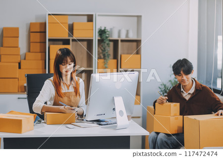 Small business owners couple entrepreneurs working with parcel, e-business, marketing, online shop, sme, entrepreneurs Small business owners couple entrepreneurs working with parcel, e-business, marketing, online shop, sme, entrepreneurs 117472474