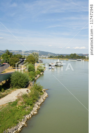 the banks of the Danube River in Linz, Austria 117472948