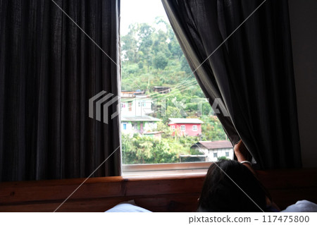Mountain View from Hotel window by Sliding Curtain Mountain View from Hotel window by Sliding Curtain 117475800