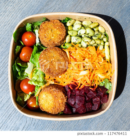 Bowl of peas, vegetables and falafel, a vegan dish in Bremen, Germany Bowl of peas, vegetables and falafel, a vegan dish in Bremen, Germany 117476411
