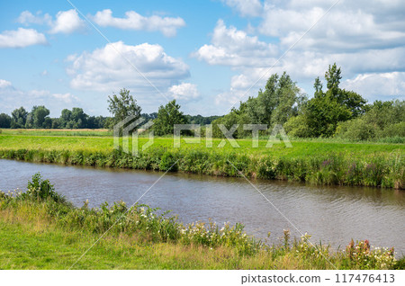 Green banks of the River Ochtum at the Kladdinger Wiesen at the borders of Bremen, Germany Green banks of the River Ochtum at the Kladdinger Wiesen at the borders of Bremen, Germany 117476413