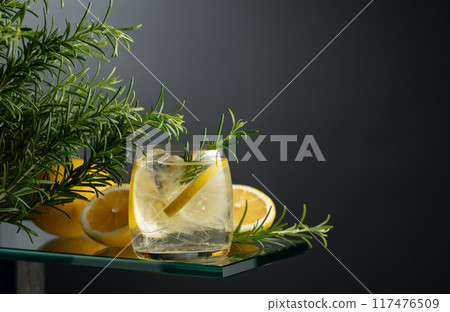 Refreshing drink with ice, lemon slices, and rosemary. Refreshing drink with ice, lemon slices, and rosemary. 117476509