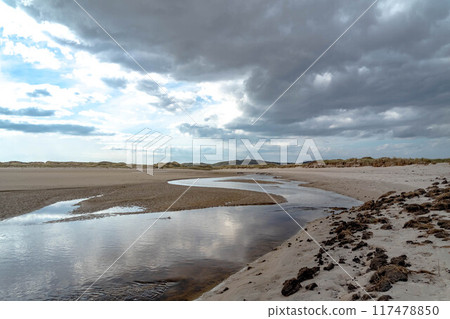 The stream that flows from Sheskinmore Nature Reserve to Ballinravey Strand between Ardara and Portnoo in Donegal - Ireland 117478850