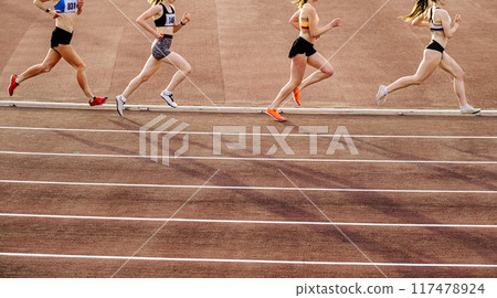 group women runner running 800 metres race in stadium 117478924