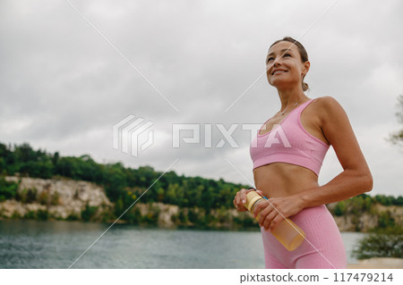 Embracing an Active Lifestyle A Passionate Fitness Enthusiast by the Waters Edge 117479214