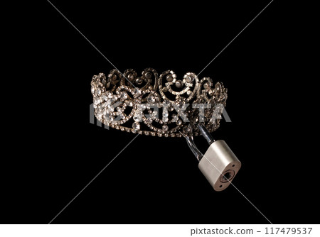 Diamond Crown with lock key for winner of competition. It mean They've practically locked the win up diamond crown. Lock key is favorite to win Miss beauty pageant contest, Black background isolated 117479537